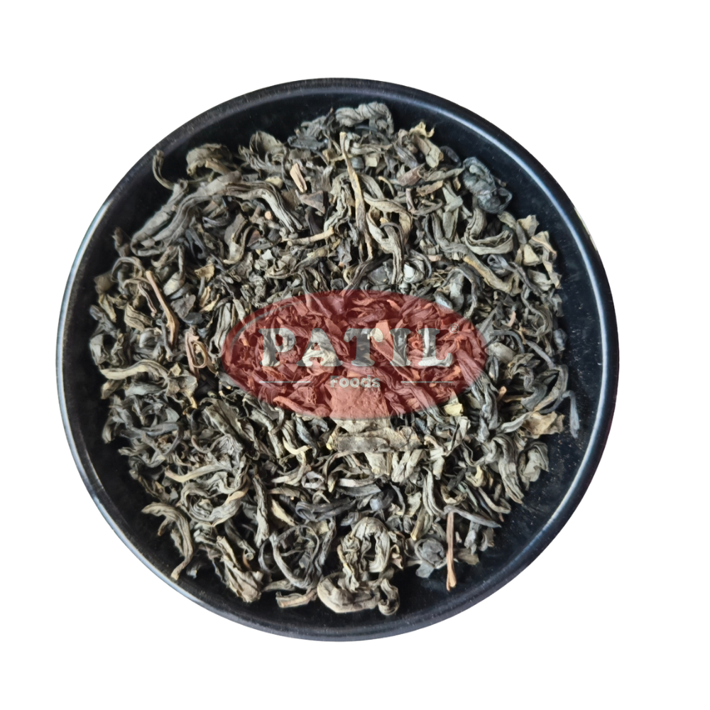 Closeup of green tea leaves showing natural texture and vibrant green color