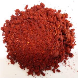 Closeup of Kolhapuri spice mix showing coarse texture and vibrant red color