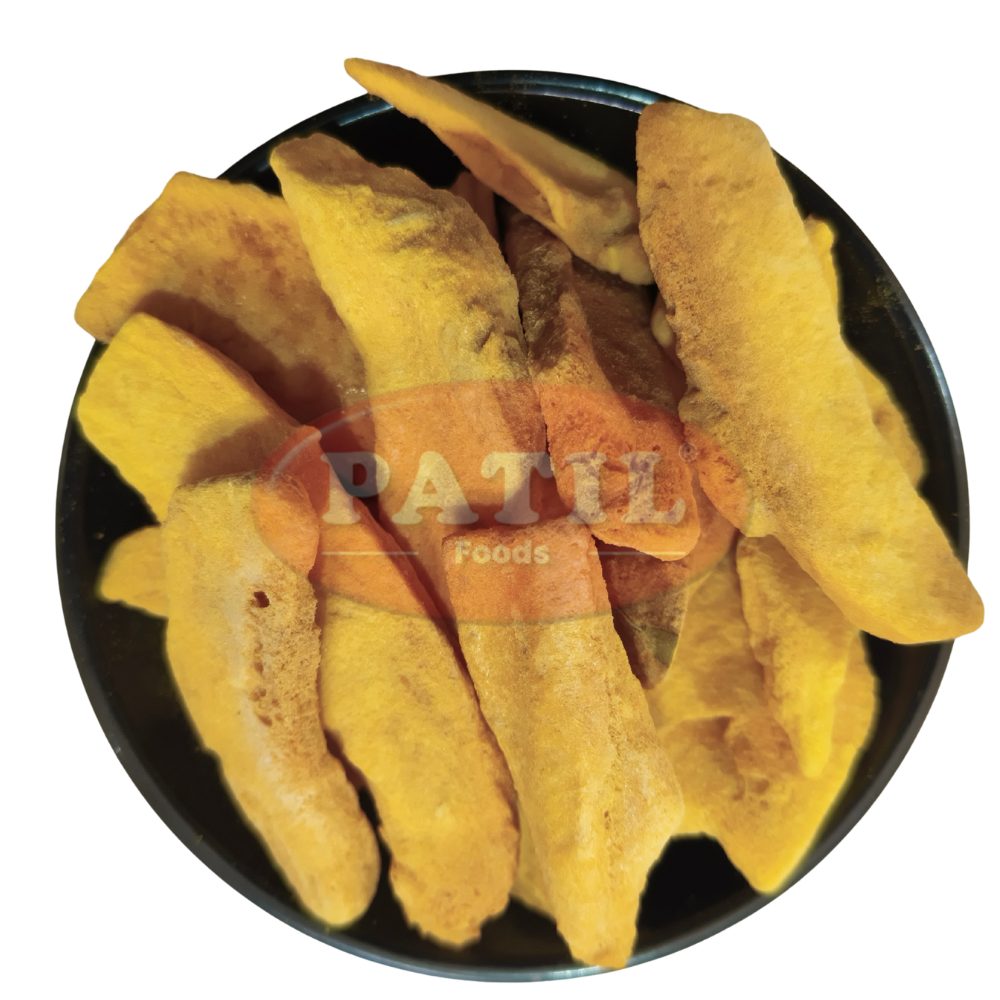 Close-up texture of freeze-dried mango slices showing crispy, porous structure and natural golden colour – Patil Foods